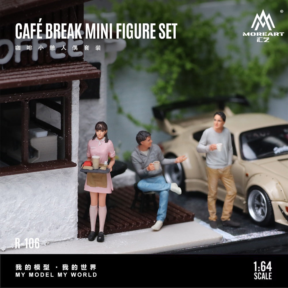 A miniature figure set themed around a café break, featuring three small figurines in front of a model building and a beige car. The set includes a waitress in a pink dress, a seated man in a grey shirt and blue jeans, and a standing man in a grey sweatshirt and khaki pants.